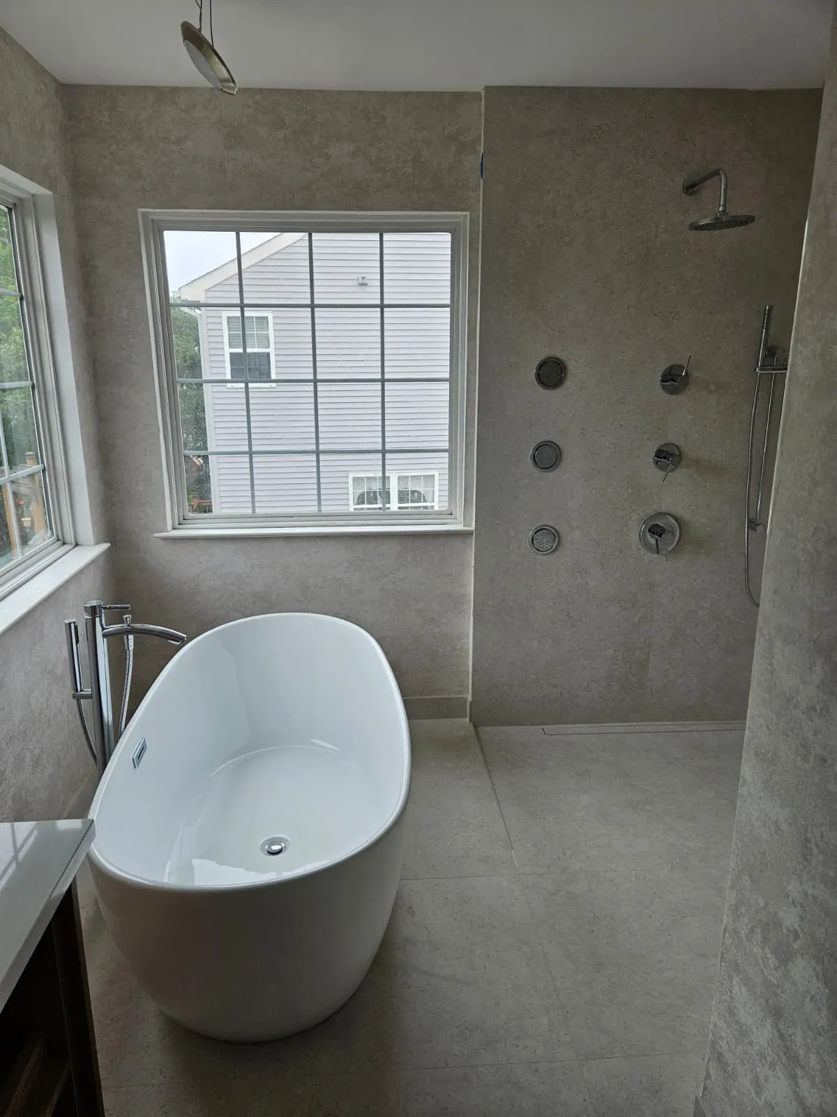 Master bathroom with freestanding tub and walk-in body-spray shower