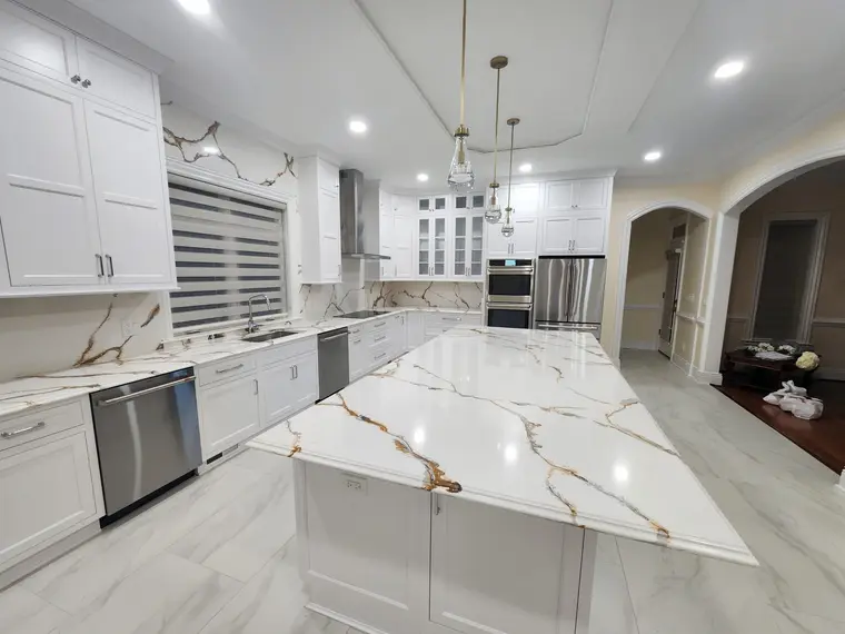Luxury white inset kitchen with gold calacatta quartz island and brass pendants