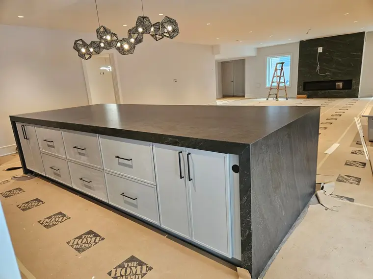 Custom entertaining space with black granite waterfall island