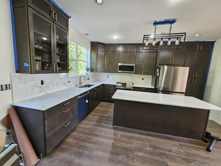 Dark espresso shaker kitchen with white quartz island and linear pendant, Northern Virginia